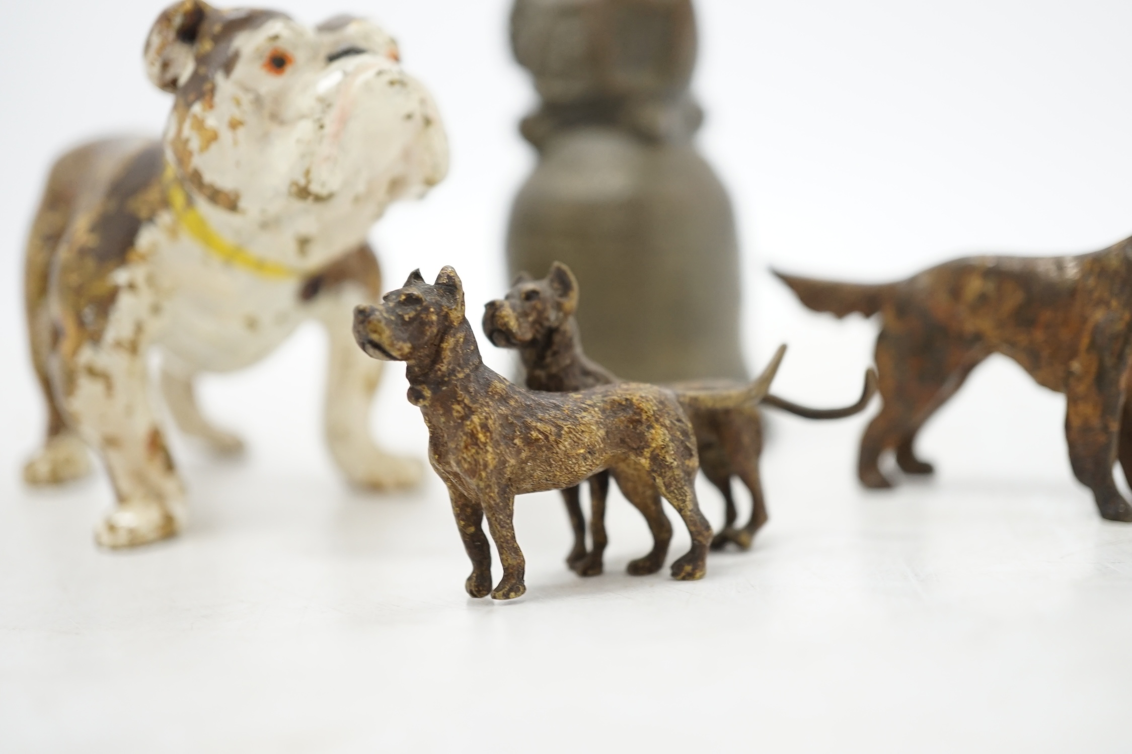 Three cold painted bronze dogs and a bronze giraffe handled bell, bell 13.5cm high. Condition - fair
